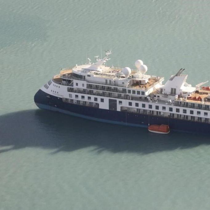 A fishing vessel in Greenland will try to free a cruise ship that ran aground with 206 people